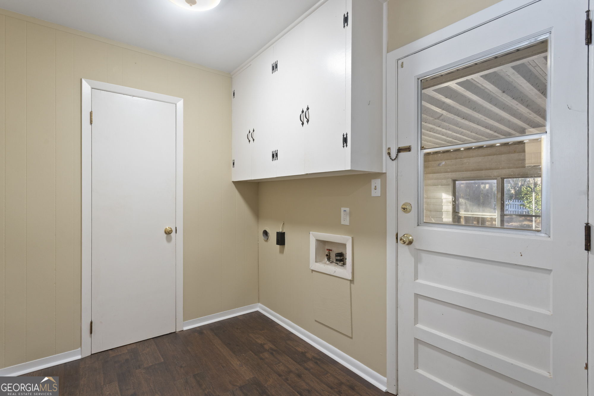 1423 Tucker Road Perry, GA 31069 - Photo 6 of 37 a view of an empty room with wooden floor and a window