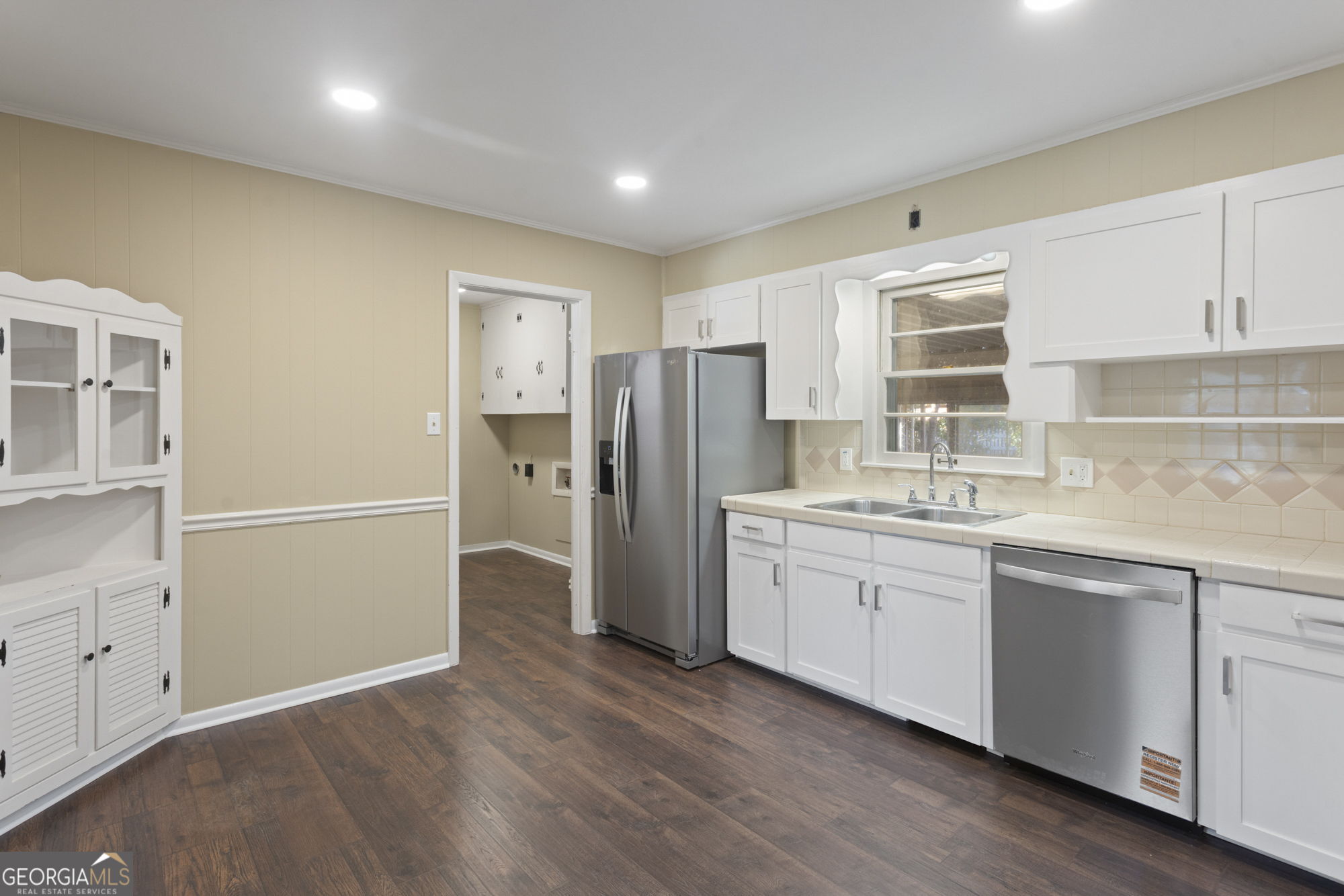 1423 Tucker Road Perry, GA 31069 - Photo 7 of 37 a kitchen with a refrigerator sink and cabinets