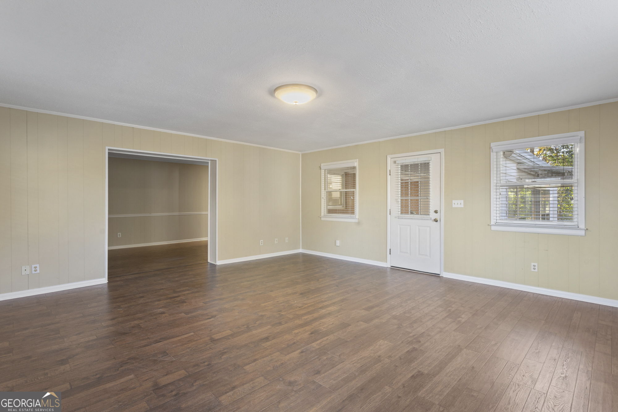 1423 Tucker Road Perry, GA 31069 - Photo 8 of 37 a view of an empty room with a window and wooden floor