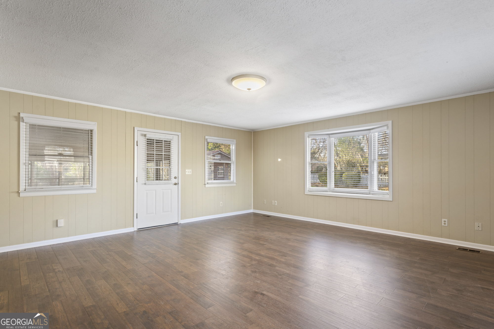 1423 Tucker Road Perry, GA 31069 - Photo 9 of 37 a view of an empty room with a window and wooden floor