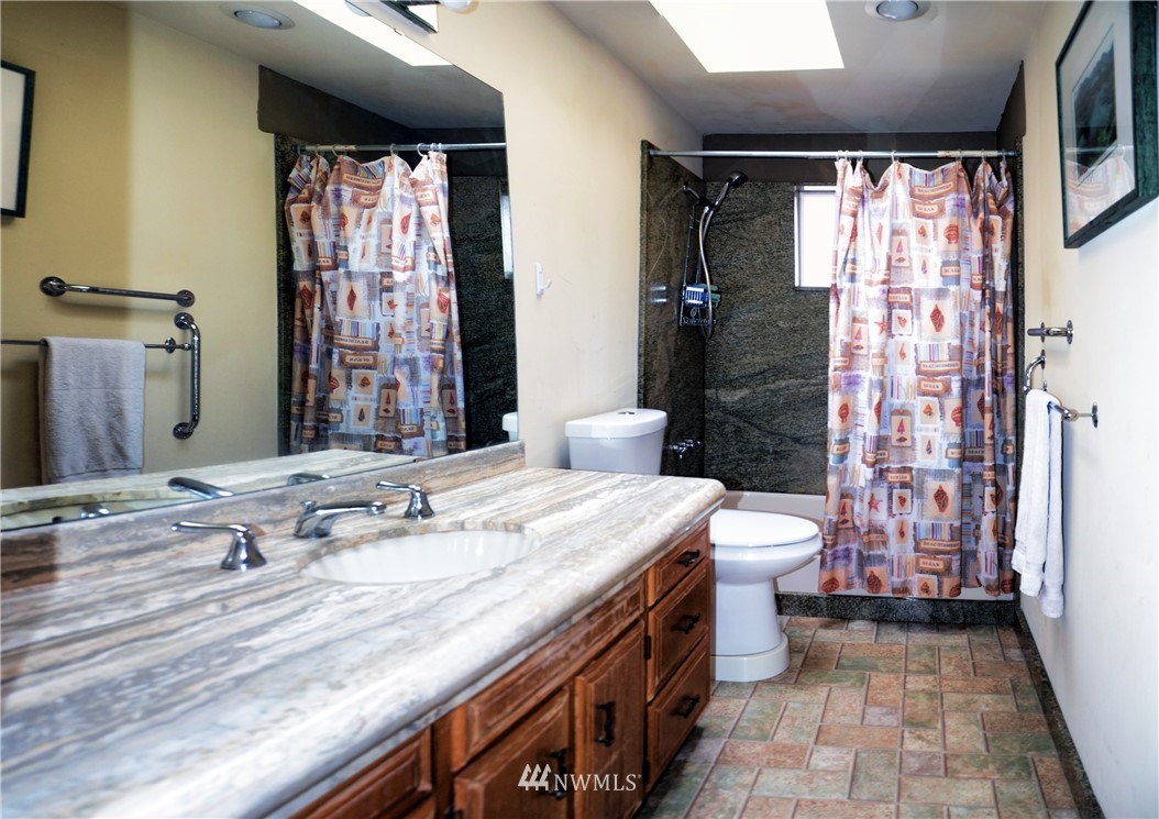 1024 South Machias Road Snohomish, WA 98290 - Photo 23 of 36 a bathroom with a sink a toilet a mirror and shower