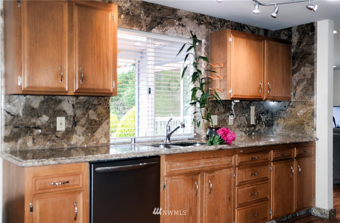 1024 South Machias Road Snohomish, WA 98290 - Photo 6 of 36 a kitchen with stainless steel appliances granite countertop a sink and cabinets