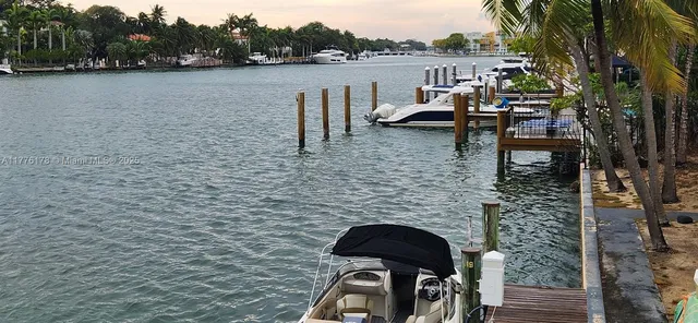 a bathroom with a granite countertop sink a toilet and mirror