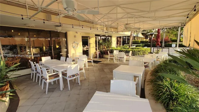 a view of a house with backyard and porch
