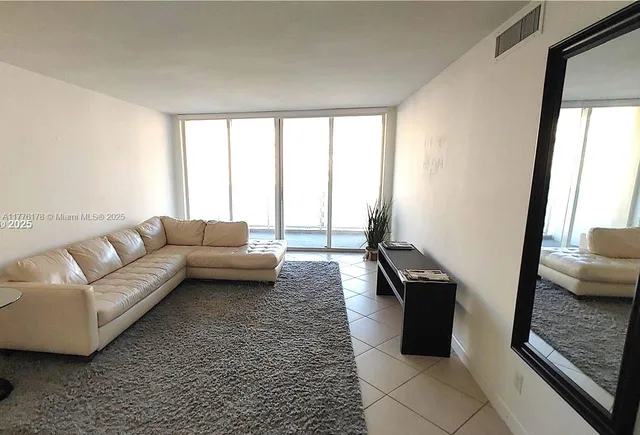 a living room with furniture and a rug