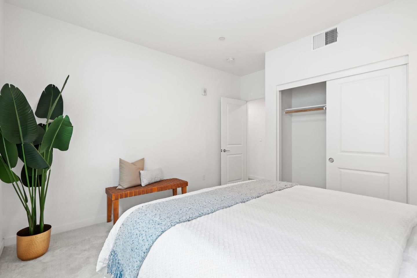 1419 Lavender Loop Milpitas, CA 95035 - Photo 19 of 38 a bedroom with a bed and a potted plant