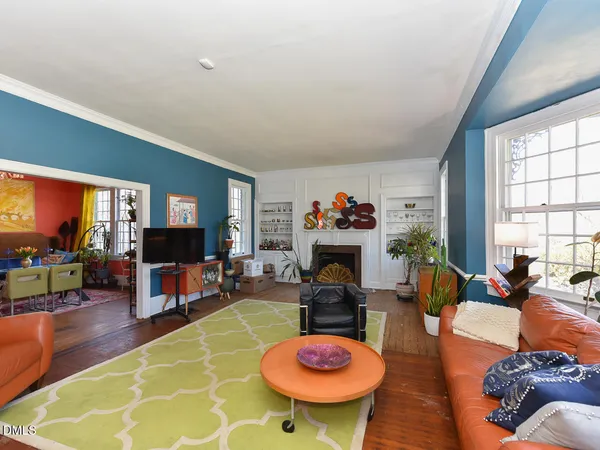 a living room with furniture a chandelier and a rug