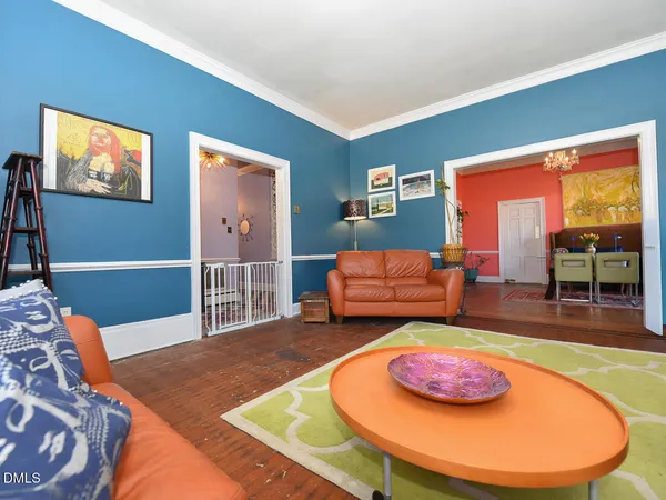 a living room with furniture and a chandelier