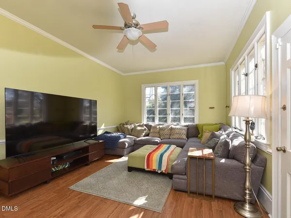 a kitchen that has a sink a stove and lots of wooden cabinets