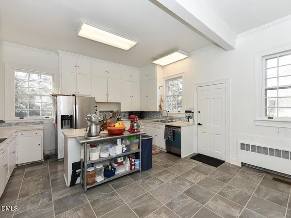 a vase of flowers sitting on a table in a bathroom
