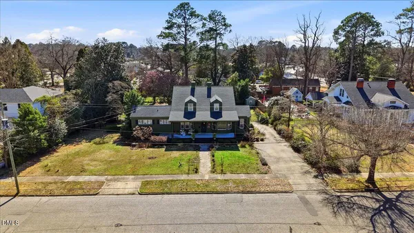 a view of a house with a yard and fountain