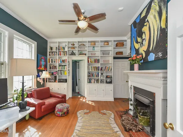 a view of empty room with wooden floor