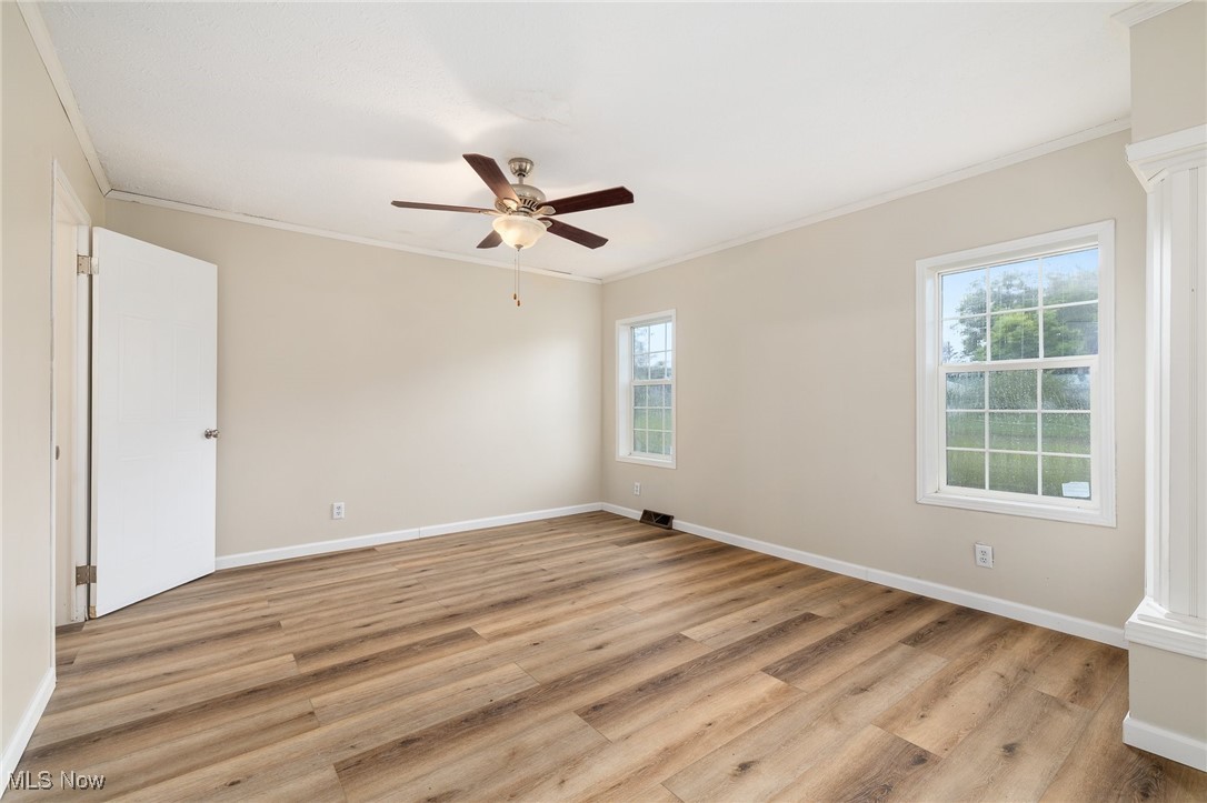 4838 Angling Rd Extension Wooster, OH 44691 - Photo 16 of 39 Empty room with crown molding, ceiling fan, and light wood finished floors