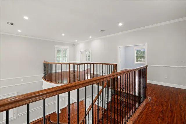 a view of staircase with lots of wooden floor and windows