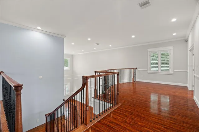 a view of staircase with wooden floor and a window