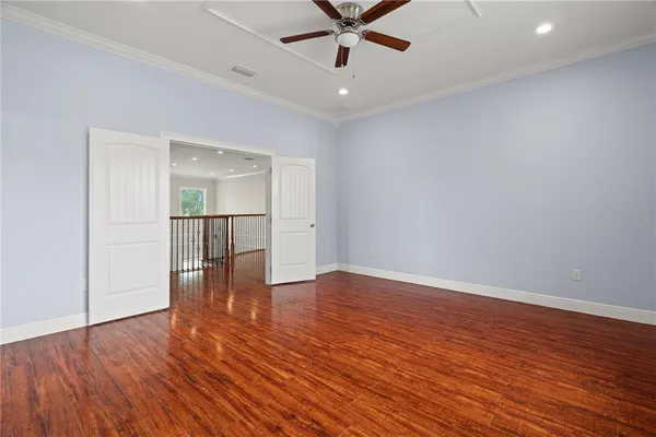 a view of empty room with wooden floor