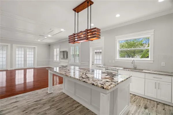 a kitchen with a stove kitchen island and couches