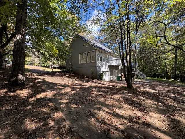 a view of a livingroom with a ceiling fan and window