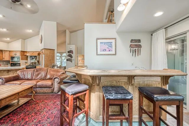 a living room with furniture a dining table and a chandelier