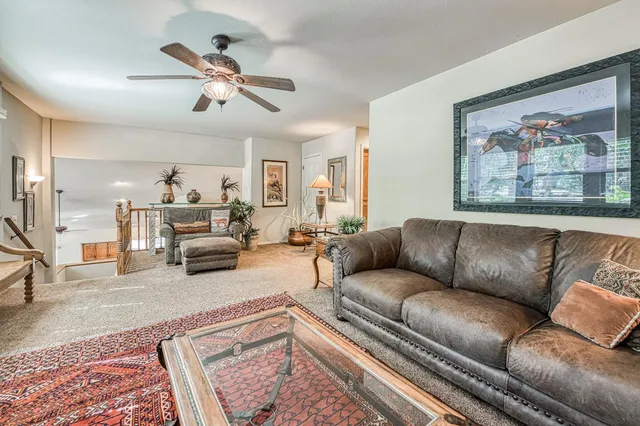 a kitchen with stainless steel appliances granite countertop a stove a sink and a chandelier