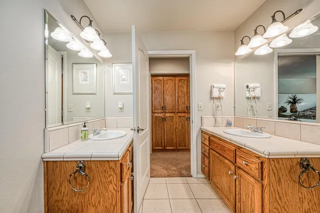 a bathroom with a granite countertop sink mirror and toilet