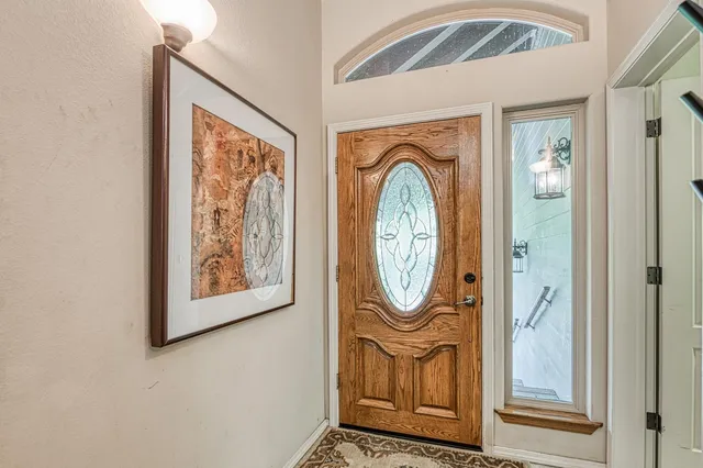 a living room with fireplace furniture and a large window