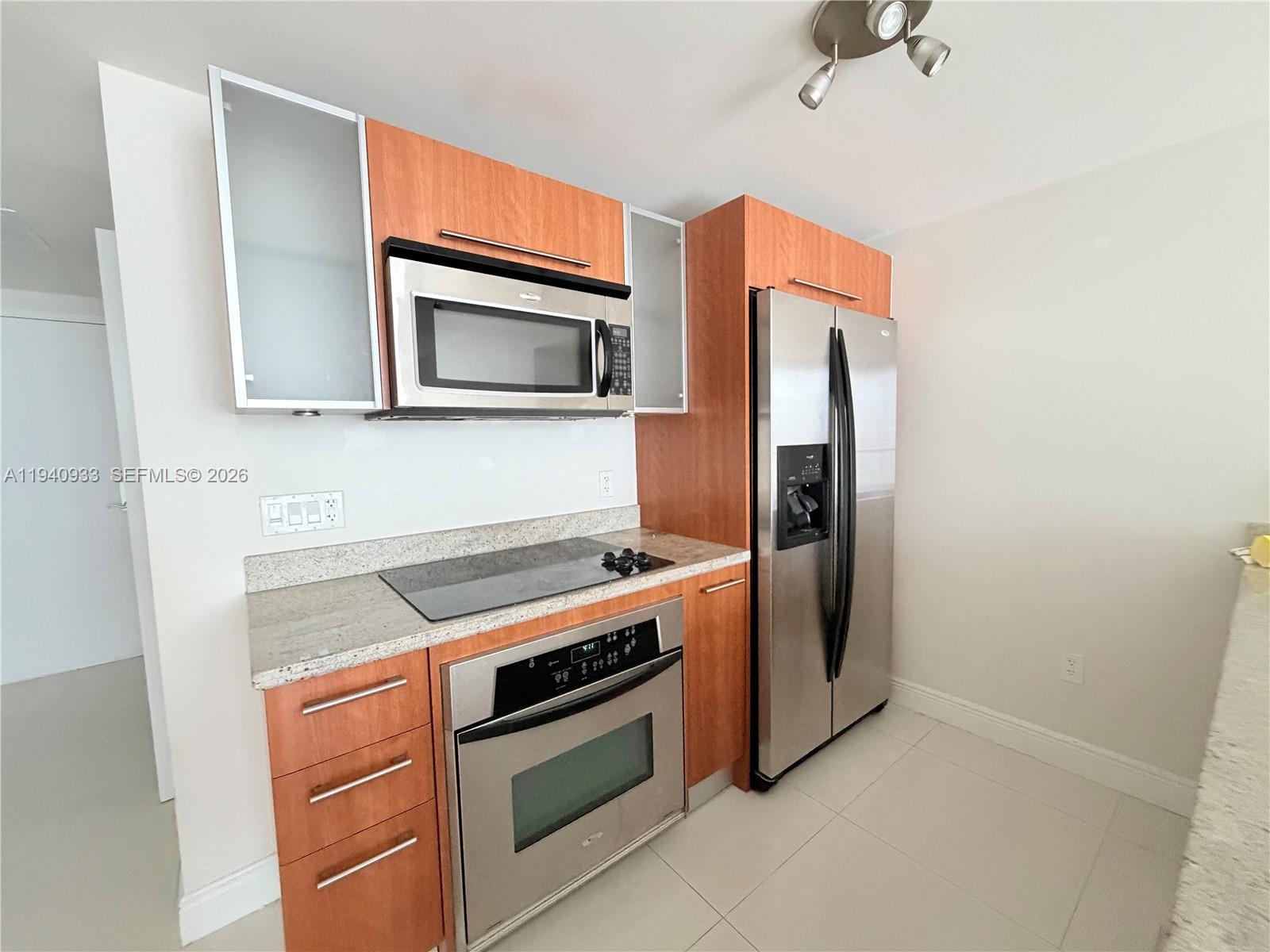 185 Southwest 7th Street, Unit 2404 Miami, FL 33130 - Photo 1 of 20 a kitchen with stainless steel appliances granite countertop a stove microwave and refrigerator