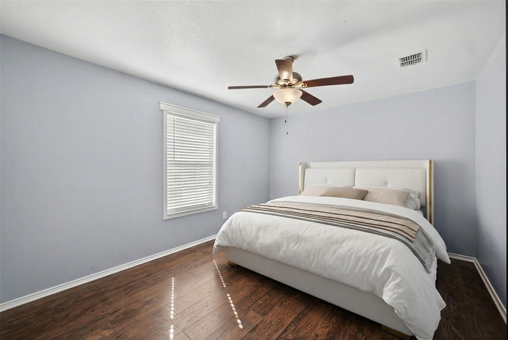 9633 Anns Way Plano, TX 75025 - Photo 26 of 37 a bedroom with a large bed window and a ceiling fan