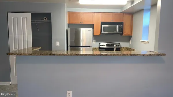 a kitchen with stainless steel appliances a sink and a microwave