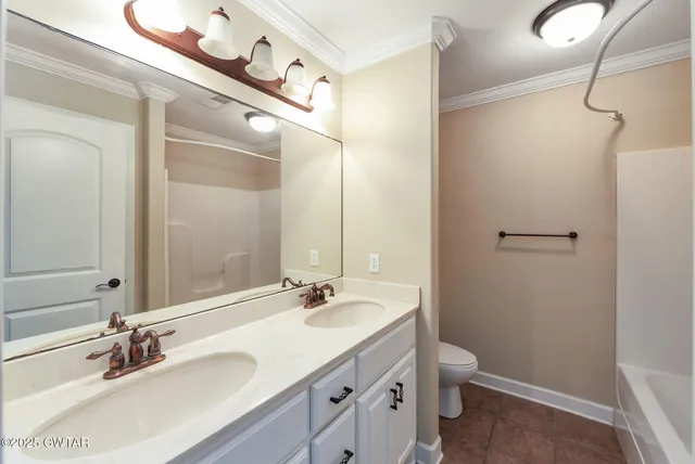a bathroom with a double vanity sink toilet and mirror