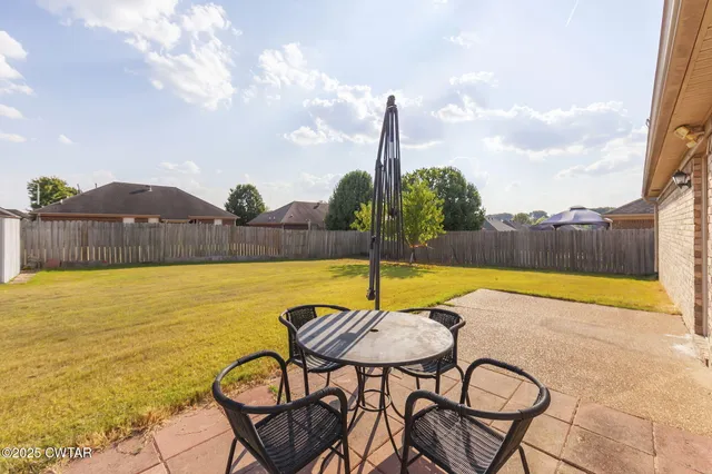 a view of a swimming pool with chair and table