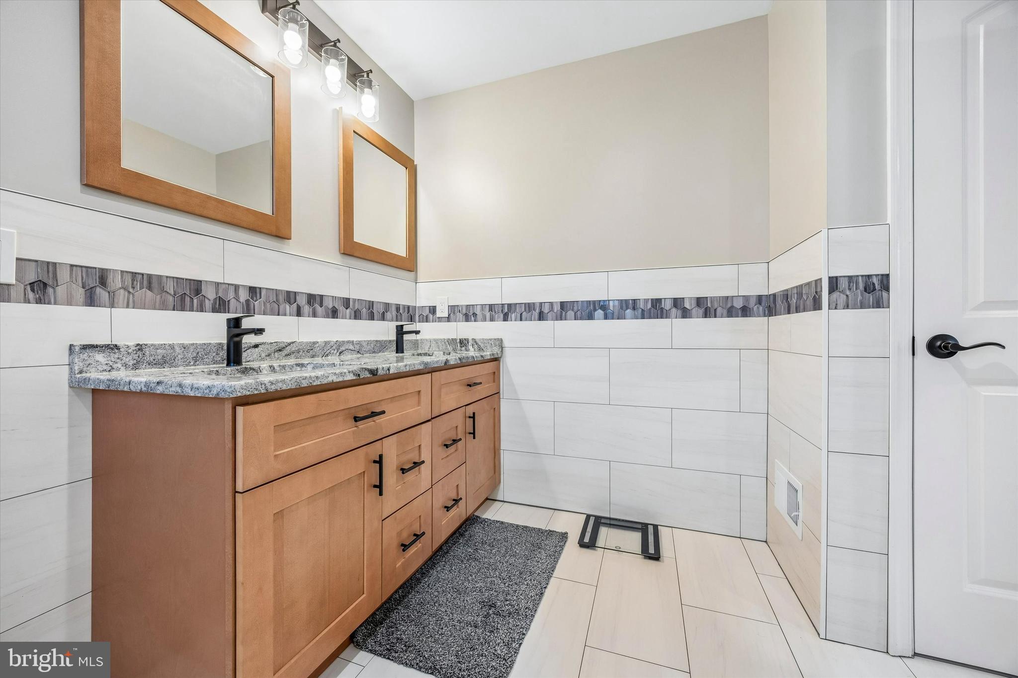 709 Shadyside Avenue Croydon, PA 19021 - Photo 25 of 40 a bathroom with a double vanity sink a mirror and a shower