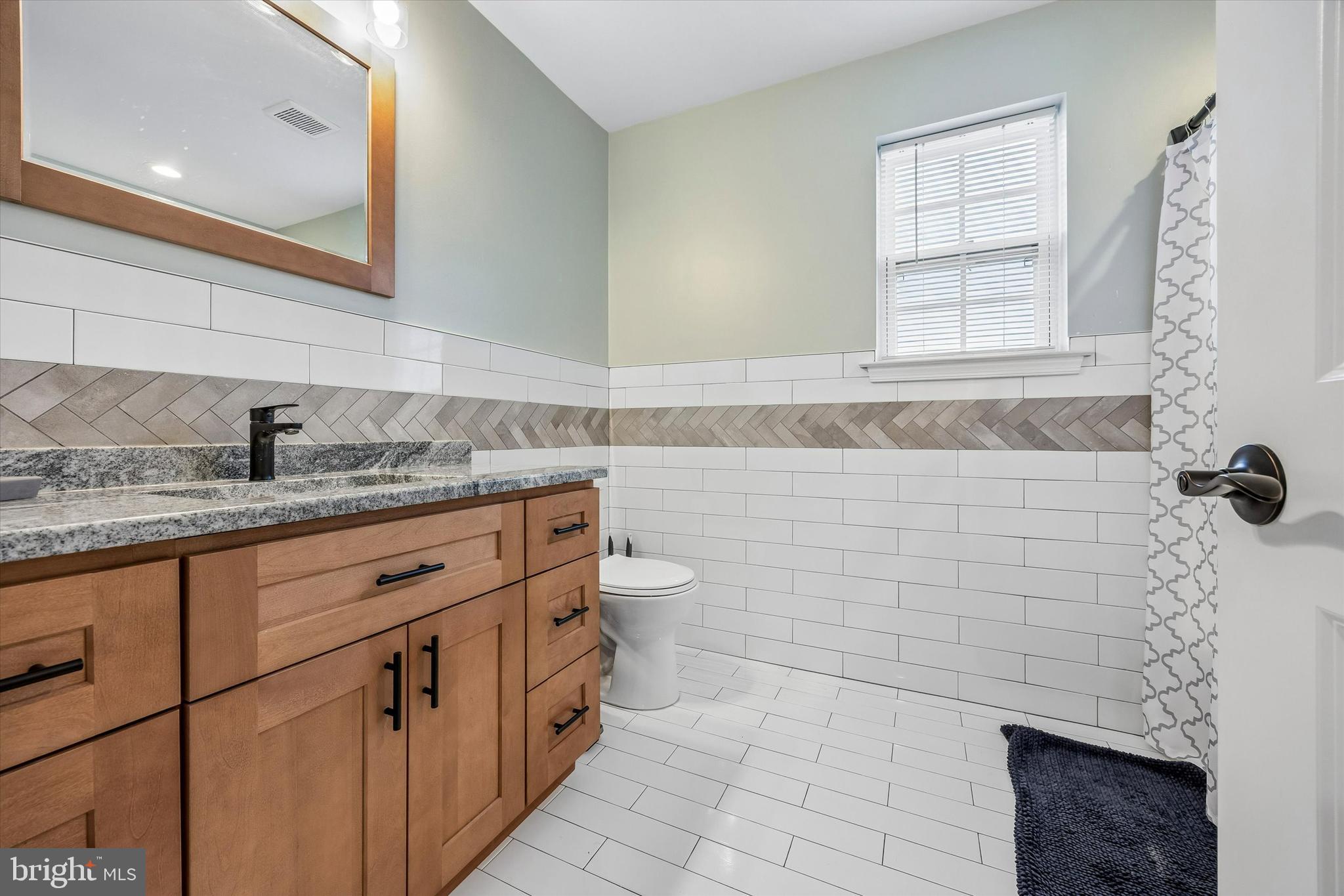 709 Shadyside Avenue Croydon, PA 19021 - Photo 27 of 40 a bathroom with a granite countertop sink a toilet and mirror