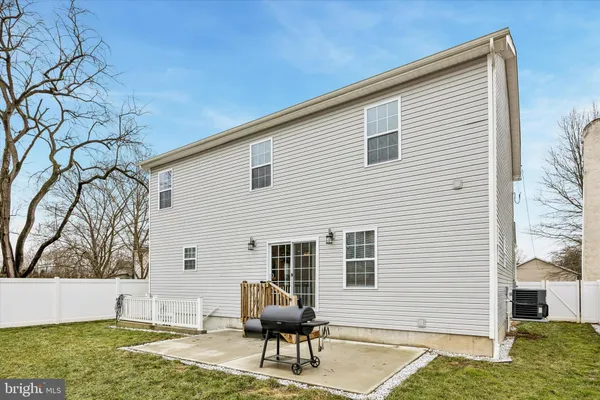 a view of house with backyard and sitting area