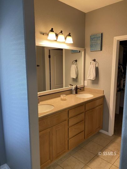 401 Acacia Street Ridgecrest, CA 93555 - Photo 23 of 42 a bathroom with a double vanity sink and mirror