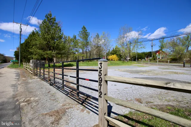 a view of a street with wooden fence