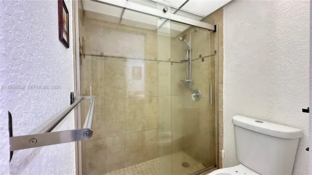 a bathroom with a shower and a toilet