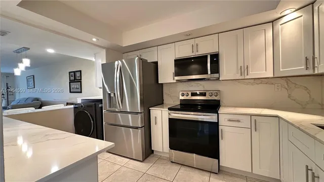 a kitchen with a sink stove and refrigerator