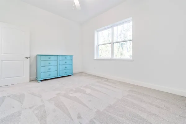 an empty room with windows and cabinet