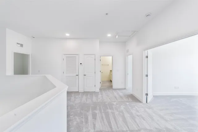 a view of a kitchen cabinets and a hallway