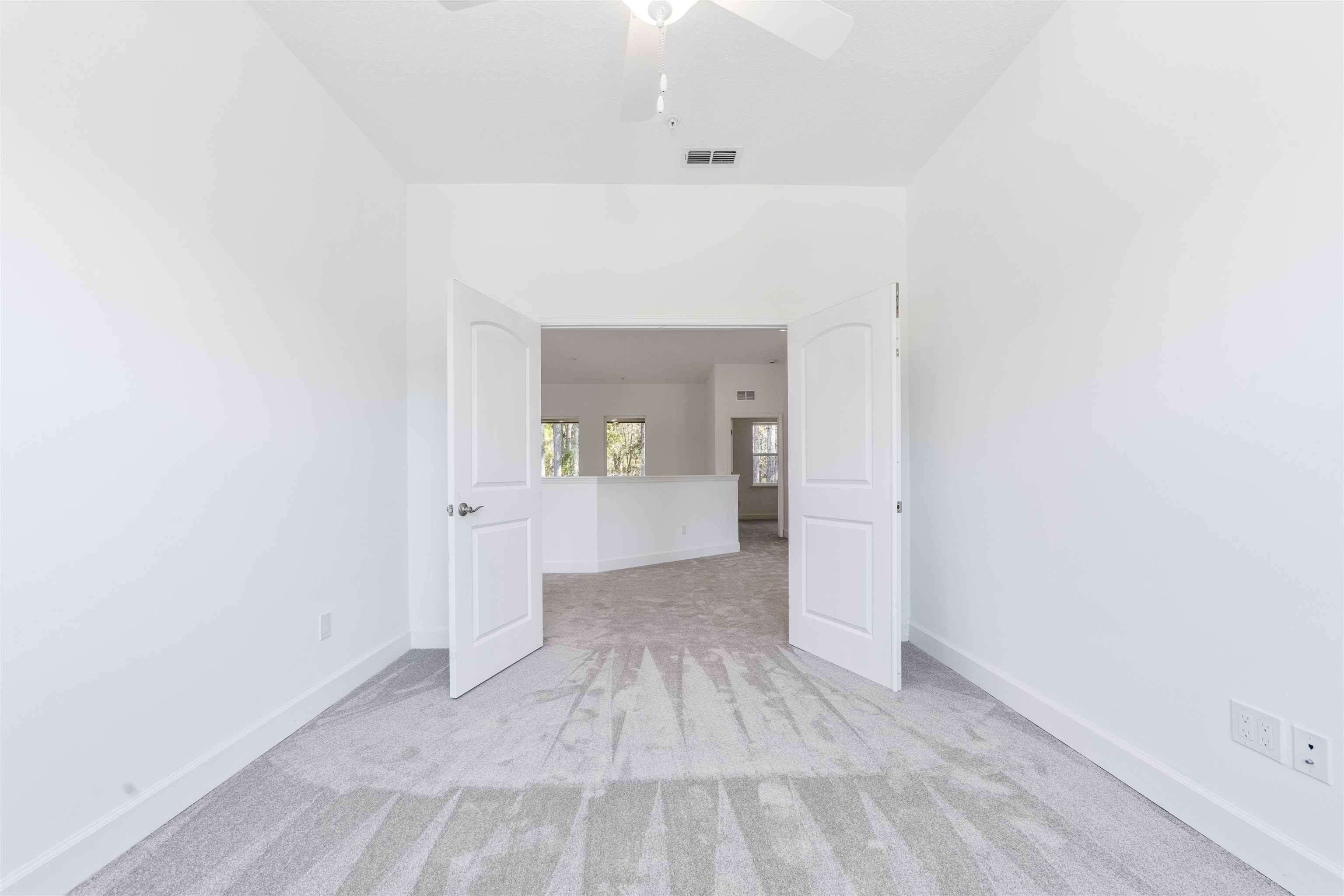 272 Grand Ravine Drive St. Augustine, FL 32086 - Photo 26 of 41 a view of a hallway with wooden floor and a bathroom
