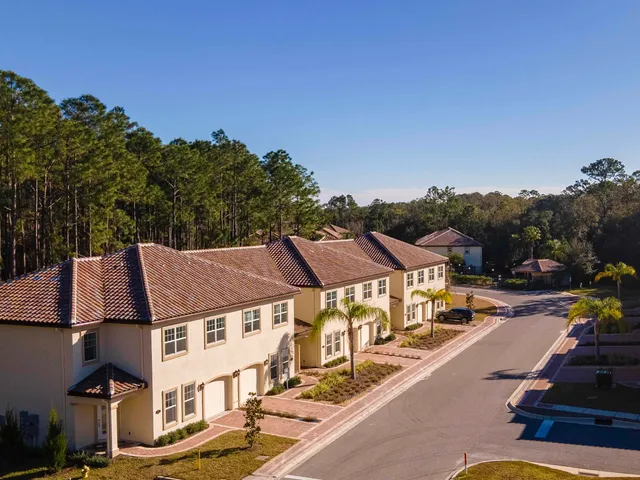 an aerial view of a residential apartment building with a yard