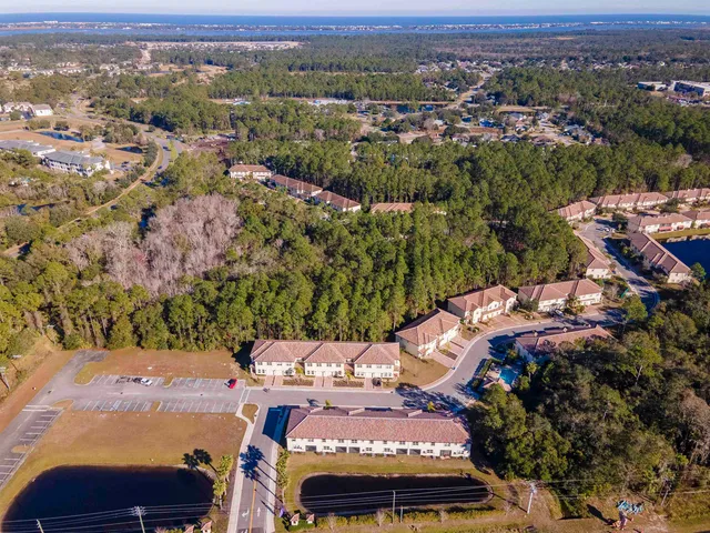 an aerial view of residential houses with outdoor space
