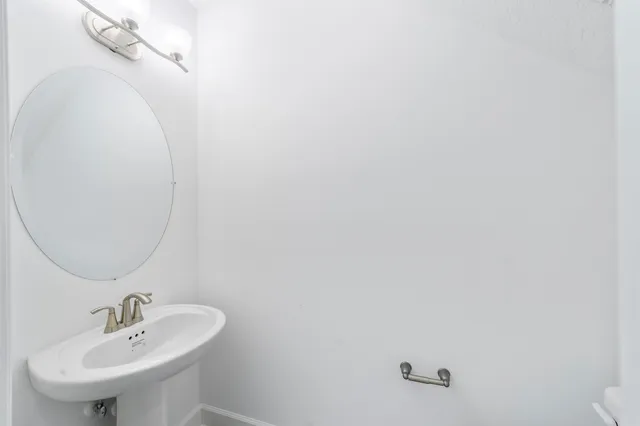 a bathroom with a sink and mirror