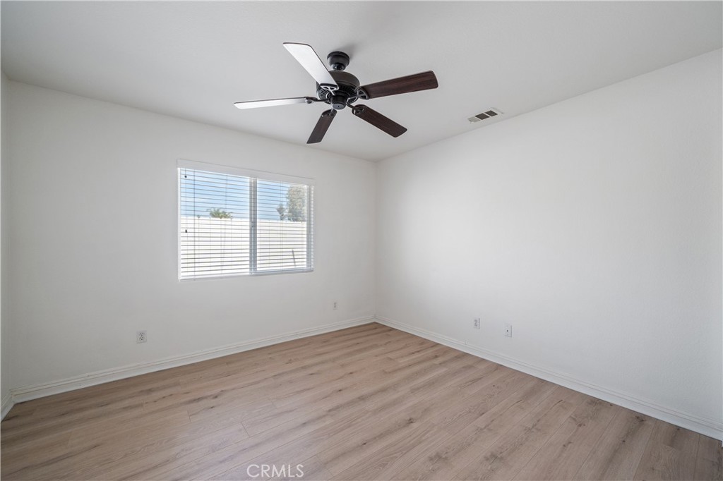 29582 Toomas Circle Menifee, CA 92587 - Photo 13 of 30 wooden floor in an empty room with a window