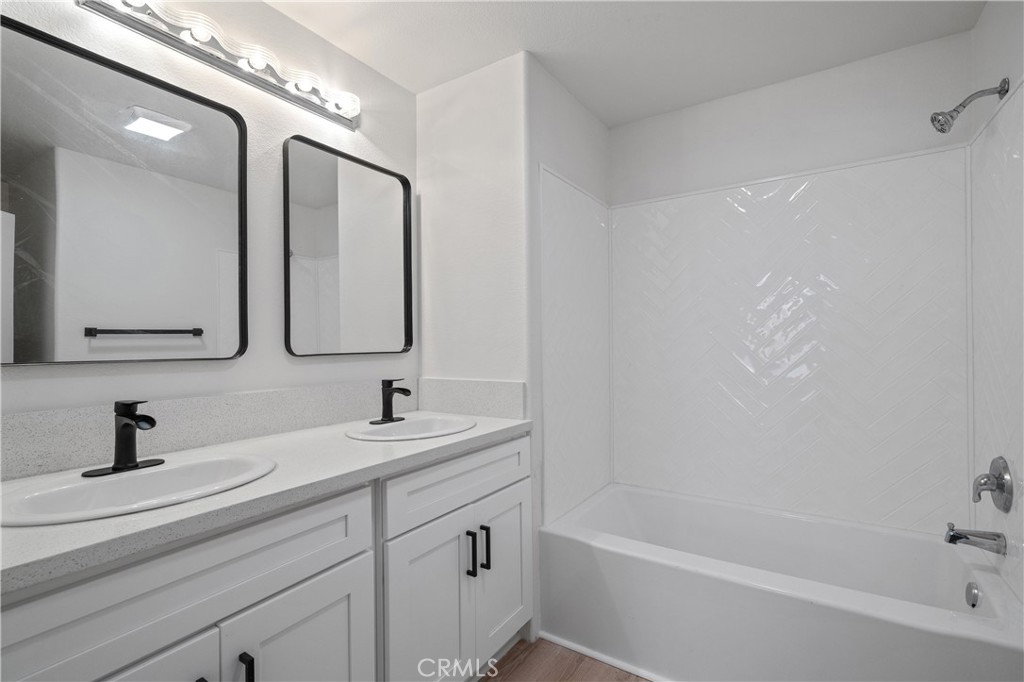 29582 Toomas Circle Menifee, CA 92587 - Photo 17 of 30 a bathroom with a tub sink double vanity and mirror