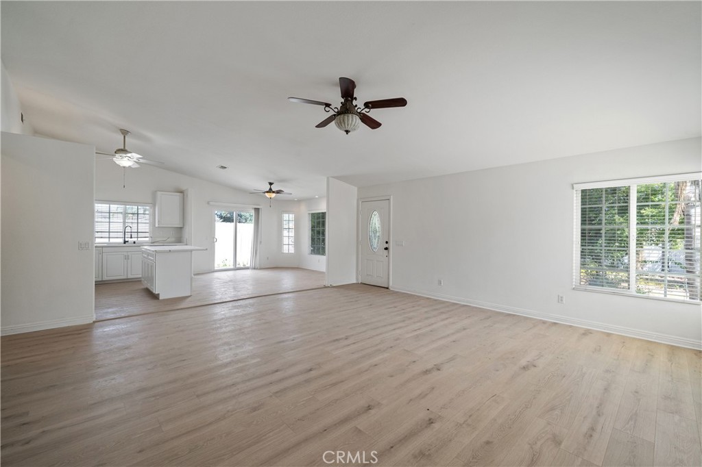 29582 Toomas Circle Menifee, CA 92587 - Photo 5 of 30 an empty room with wooden floor windows and ceiling fan