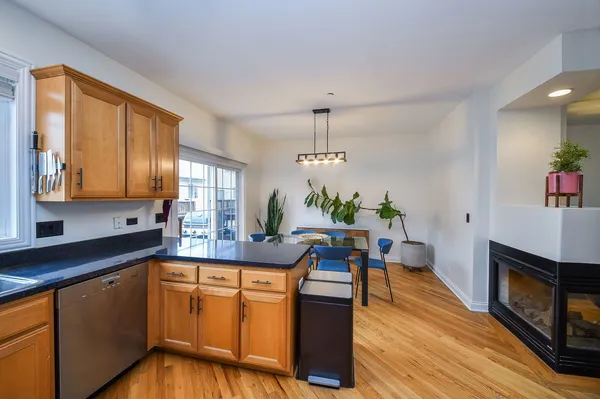 a kitchen with granite countertop wooden floors and white cabinets