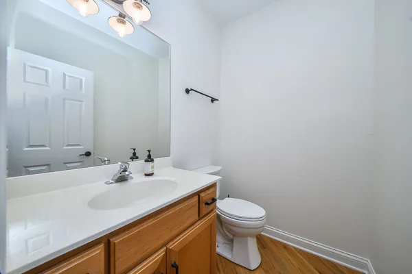 a bathroom with a sink mirror and toilet