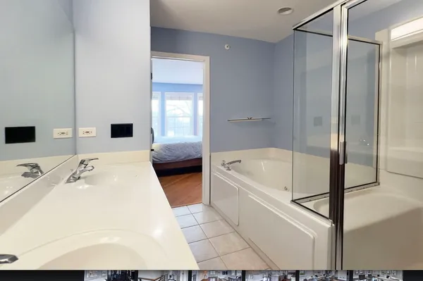 a en suite bathroom with a tub shower and sink